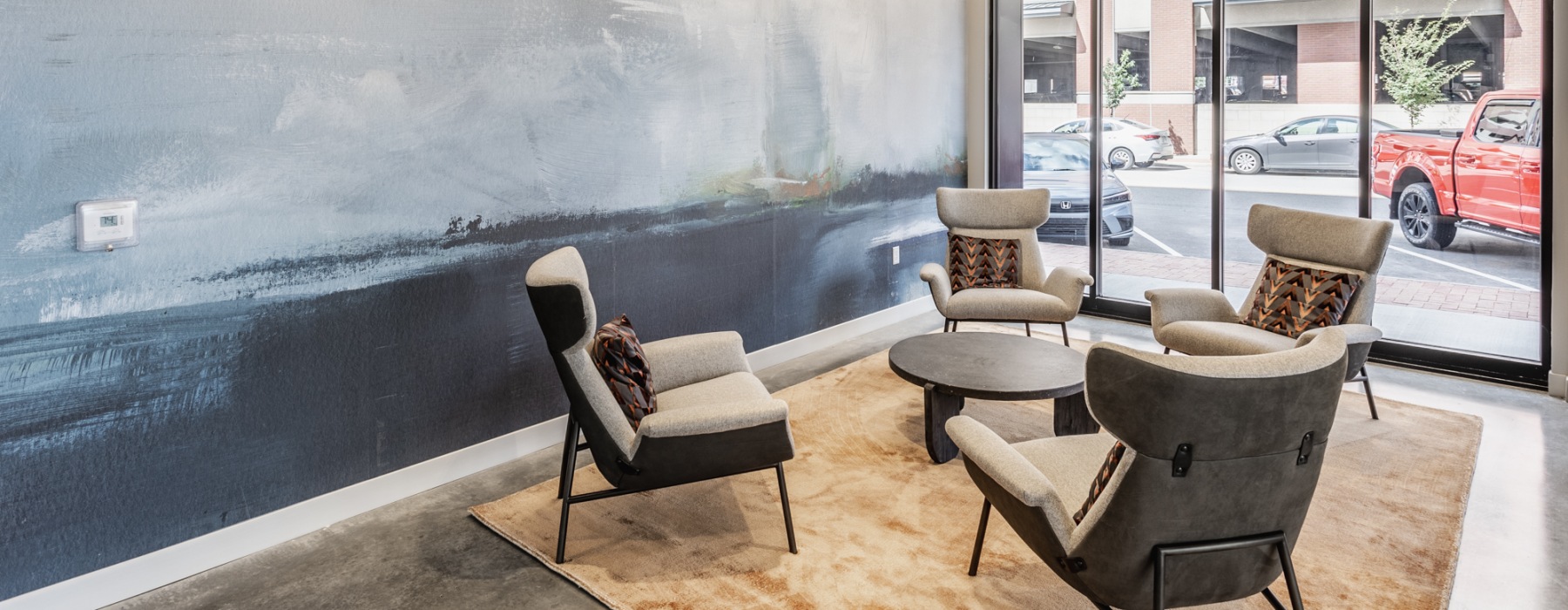 a room with chairs and a large window